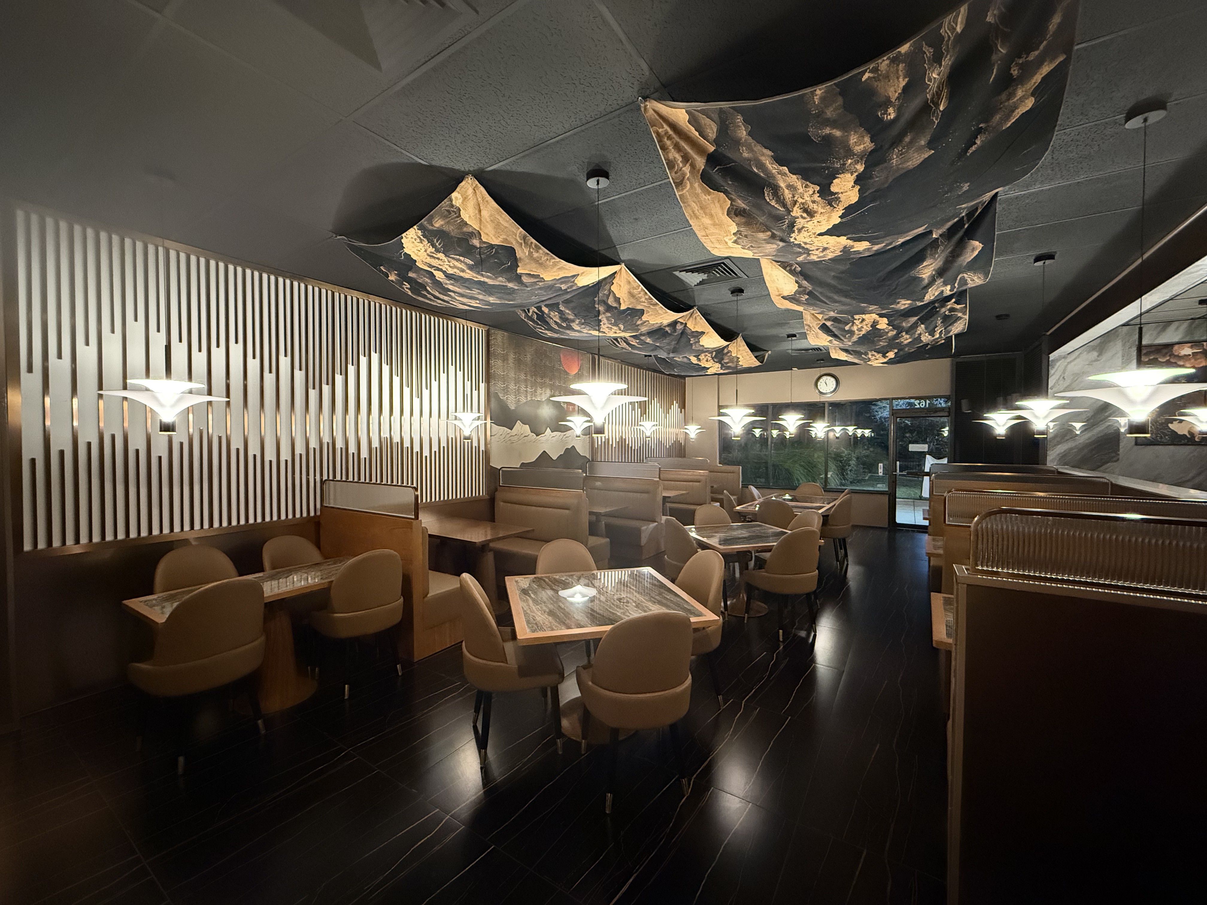 Booth seating beneath pendant lighting in the Bao & Blade dining room