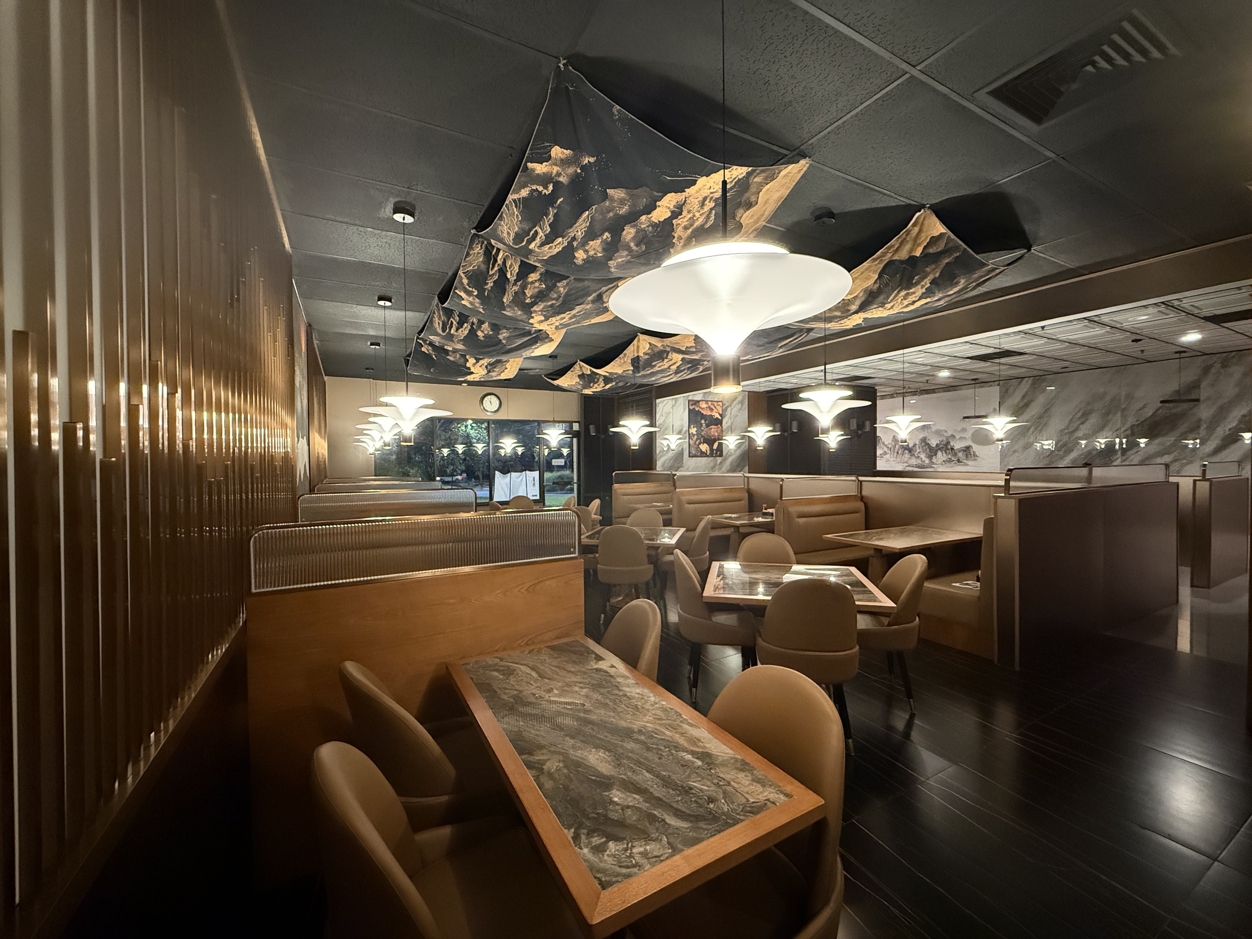 Warm wood slat wall and booth seating in the dining room